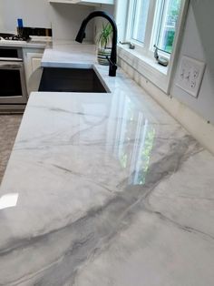 a white marble counter top in a kitchen