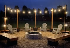 an outdoor fire pit surrounded by chairs and lights