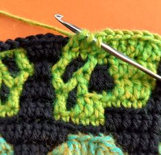 the crochet is being worked on with scissors