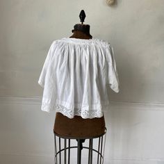 Hello and welcome to the Textile Trunk! Please follow us on Instagram , our user name is textiletrunk A fabulous rare find! Lace trimmed, GORGEOUS! his textile is a choir blouse dating from c 1900 or late 1800's. Made of crispy white cotton , This shirt was a Choir blouse and has lovely mends! ~ it was used and loved. There are some small stains on the back of one of the sleeves near the mends that would probably come out with some spot bleach work! I LOVE this blouse!! ( Eshirt 11094) MEASUREME Cotton Broderie Anglaise Cottagecore Tops, Vintage Cotton Blouse With Lace Cuffs, Cottagecore Cotton Tops With Broderie Anglaise, Cottagecore Broderie Anglaise Cotton Tops, Cotton Peasant Top With Lace Trim For Daywear, Vintage Cotton Tops With Broderie Anglaise, Fitted Cotton Peasant Top With Lace Trim, Vintage Cotton Peasant Top For Daywear, Fitted Vintage Cotton Lace Tops