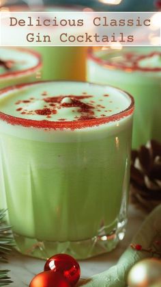 two glasses filled with green liquid and topped with red sprinkles on top