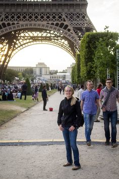 two people standing in front of the eiffel tower