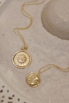 A gold rotating necklace which features the face of the sun on one side and the face of the moon on the other. Comes in 2 sizes. Small charm is 1” wide and hangs from a 16” chain Big charm is 1.5” wide and hangs from a 21” chain Sun And Moon Design Round Pendant Necklace, Vintage Sun And Moon Round Necklaces, Spiritual Sun And Moon Design Round Pendant Necklace, Yellow Gold Sun And Moon Round Pendant Necklace, 14k Gold Sun And Moon Pendant Necklace, Moon Gold, Small Charms, Beautiful Stories, Sun And Moon