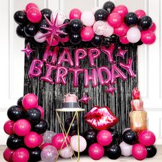 a birthday party with black, pink and white balloons