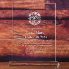 a clear glass plaque with the words luna mars on it and an image of a firefighter's helmet