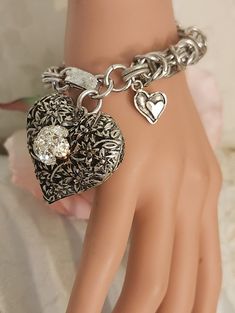 "This adorable new chunky heart charm bracelet features a large 1 1/4\" textured puffy heart charm that has been embellished with a vintage rhinestone button. Along with a smaller double heart charm, it hangs on a gorgeous intricate 3/8\" vintage silver tone chain. This pretty charm bracelet is 7 1/4\" long and closes with a strong Sarah Cov fold-over clasp. Our unique jewelry is a great gift for Christmas, a birthday or an anniversary....or just buy it for yourself.   I have included free insur Vintage Bracelet Jewelry For Valentine's Day, Vintage Adjustable Heart Bracelet For Valentine's Day, Vintage Heart Bracelet For Valentine's Day Anniversary, Nickel-free Vintage Heart Bracelet As Gift, Vintage Nickel-free Heart Bracelet As Gift, Vintage Nickel-free Heart Bracelet Gift, Nickel-free Heart-shaped Metal Charm Bracelet, Vintage Heart Bracelet For Valentine's Day, Vintage Heart Charm Bracelet For Valentine's Day