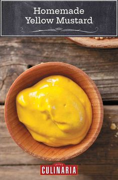 a wooden bowl filled with yellow mustard