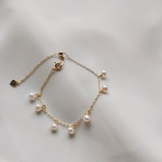 DAINTY SMALL PEARL BRACELET | FRESHWATER PEARL BRACELET | 14K GOLD FILLED PEARL BRACELET | STERLING SILVER PEARL BRACELET | WHITE PEARL GOLD BRACELET | BRIDAL BRACELET | GOLD BRACELET |  Ellie Bracelet 🤍 S T Y L E 🤍 * 7 small freshwater pearls with 14k gold-filled or 925 sterling silver chain bracelet. * The matching necklace version here👉:  https://www.etsy.com/au/listing/823767472 🤍 M E A S U R E M E N T S 🤍 * Length: approx. 20cm (adjustable to a shorter length with sliding closure bead) or 15cm + 5cm extender * Pearl: approx.5mm 🤍 M A T E R I A L S 🤍 * Freshwater Pearl * Yellow Gold: 14k gold-filled  * Silver: 925 Sterling Silver 🤍 P E R S O N A L I S E D 🤍 If you wish to have your jewelry made with other shapes or numbers of pearls, or if you wish to make any other modificati Ellie Bracelet, Pearl Gold Bracelet, Silver Pearl Bracelet, Pearl Charm Bracelet, Gold Pearl Bracelet, Dainty Gold Bracelet, Bracelet Dainty, Freshwater Pearl Bracelet, Silver Chain Bracelet