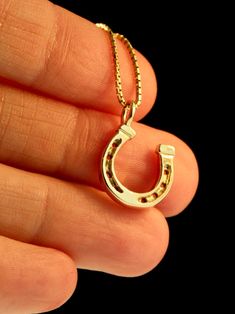 "Saddle up wearing this miniature, good-luck Horseshoe charm! It is cast in solid 14k gold and is 9/16\" in diameter. Wear just one or collect several of these darling horseshoe charms for a barrel full of good luck! The chain is not included in the price. If you would like a chain please select the stye and length from the option menu. If you would prefer a different style or length please contact us. This item usually ships the same or next business day. All Marty Magic Jewelry is packaged in Gold Hallmarked Horseshoe Jewelry, 14k Yellow Gold Horseshoe Jewelry, 14-karat Yellow Gold Horseshoe Jewelry, Gold Engraved Horseshoe Jewelry, Horseshoe-shaped Yellow Gold Jewelry Gift, Horseshoe Shaped Yellow Gold Jewelry Gift, Horseshoe Necklace Gold, Good Luck Horseshoe, Magic Jewelry