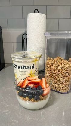 yogurt, granola, and fruit are on the counter