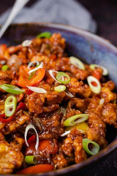 a bowl filled with meat and vegetables on top of a table