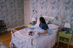 a woman laying in bed with her dog