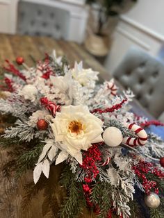 an arrangement of flowers and candy canes on a table