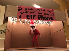 an elf is in a cardboard box with a sign that says, you used to call me on my eif phone