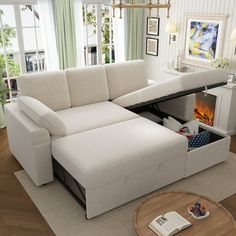 a living room with a sectional couch and coffee table in front of the fire place