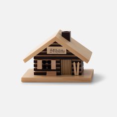 a small wooden house with the word shittie written on it