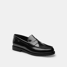 A modern update on a timeless style our Reagan loafer features a rugged rubber lug sole. Finished with a traditional penny-keeper the wear-with-everything design is crafted of smooth leather with a subtle shine. | Coach Reagan Loafer Shoes Size 10.5 - Black Classic Coach Loafers For Formal Occasions, Classic Business Dress Shoes With Lug Sole, Coach Round Toe Business Loafers, Classic Coach Slip-on Loafers, Coach Business Loafers With Round Toe, Coach Classic Slip-on Loafers, Classic Dress Shoes With Lug Sole For Work, Classic Dress Shoes With Lug Sole, Classic Coach Loafers With Leather Sole