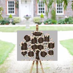 a family tree on an easel in front of a house