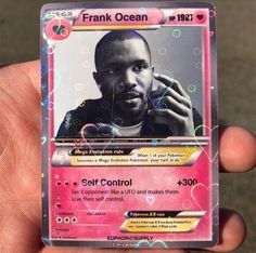 a person holding up a pink card with an image of frank ocean on it's back