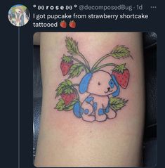 a small dog with strawberries on it's leg is shown in this tattoo