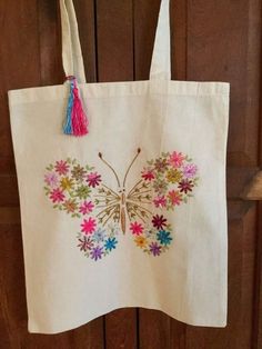 a white tote bag with colorful flowers on it