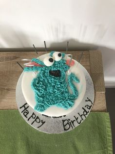 a birthday cake made to look like a cookie monster with eyes and antennae on it