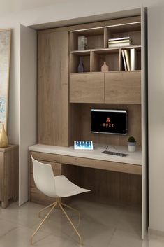 a computer desk with a monitor and keyboard on it in front of a bookcase