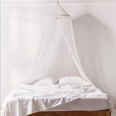 a bed with a white canopy over it