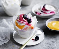 three desserts on small plates with spoons next to them