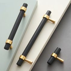 two black and gold handles are on the wall