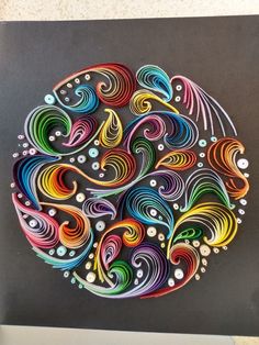 an intricately designed paper art piece is displayed