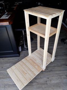 a wooden shelf sitting on top of a hard wood floor