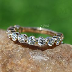 a diamond ring sitting on top of a rock