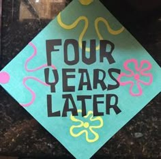 a blue and green graduation cap with four years later written on it