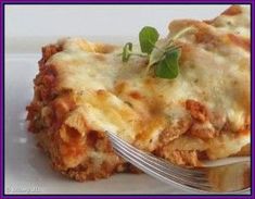 a white plate topped with lasagna and a fork