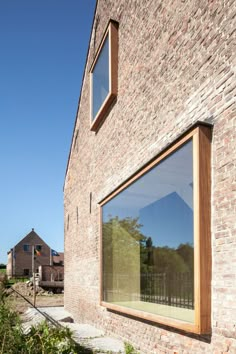 a brick building with two windows on the side