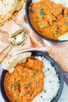 two bowls filled with rice and curry next to pita bread on a tablecloth