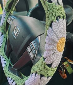 crochet steering wheel cover of sage green daisies Sage Green Car Interior Decor, Green Car Interior Aesthetic, Crochet Sage Green, Sage Green Car Interior, Sage Green Car Accessories, Car Decorations Interior Green, Sage Green Car Decor, Green Car Interior Decor, Sage Green Jeep