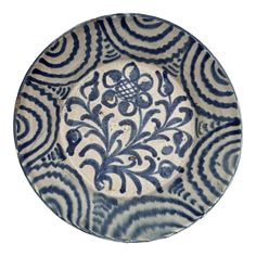 a blue and white bowl with designs on it