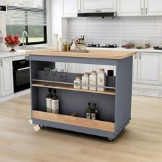 an island in the middle of a kitchen with bottles on it