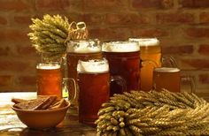 a table topped with lots of different types of beer glasses and mugs filled with liquid