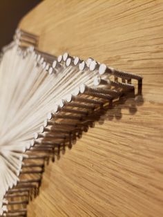 a wooden table topped with lots of white items on top of it's sides