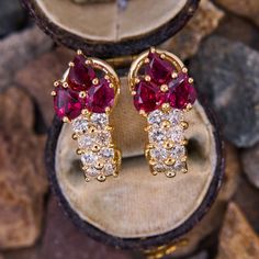 These striking earrings are each accented with three (3) pear mixed cut natural rubies and eight (8) prong set, round brilliant cut diamonds. The earrings measure 18.3mm X 8.5mm. The earrings are finished with hinged omega backs for pierced ears. Vintage Ruby Rings, Ruby Gold Earrings, Ruby Diamond Earrings, Antique Engagement Rings Sapphire, Ruby Ring Vintage, Exotic Jewelry, Ruby Rings, Gold Earrings For Women