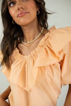 If you're looking for the perfect "date night" outfit, look no further! This gorgeous women's peach blouse is a beautiful blouse to pair with jeans or a skirt! Our Peach Ruffle Blouse is a v-neck blouse made with 100% Cotton. Elasticized on the neckline. It has short puff sleeves with elastic cuffs. Finished clean hem. Fits true to size. Available in women's sizes: Small Medium Large Outfit Utah, Outfit Date Night, Outfit Date, The Perfect Date, Peach Blouse, Cream Blouse, Cream Top, Perfect Date, Beautiful Blouses