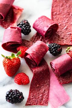 berries, raspberries and rolled up dough on a marble surface