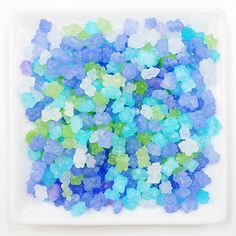 blue and green gummy bears on a white plate