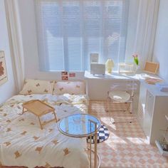 a small bedroom with a bed, desk and chair in front of a large window