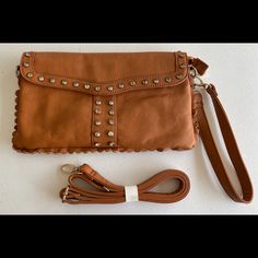 Pretty Brand New Tan Vegan Clutch. Crystal Trim. Snap Closure. Strap Option. Pockets Inside. Zipper Pouch Too! Crystal Trim, Crystal Stones, Leather Clutch, Zipper Pouch, Stones And Crystals, Snap Closure, Inside Pocket, New Color, Vegan Leather