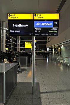 an airport terminal with people waiting for their luggage