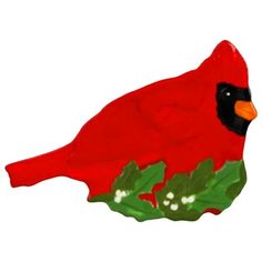 a red bird sitting on top of a green plant